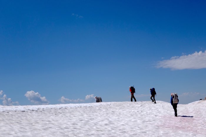 Trekking over a snow-covered pass along the divide between the Sky Top Lakes and Aero Lakes Basins.