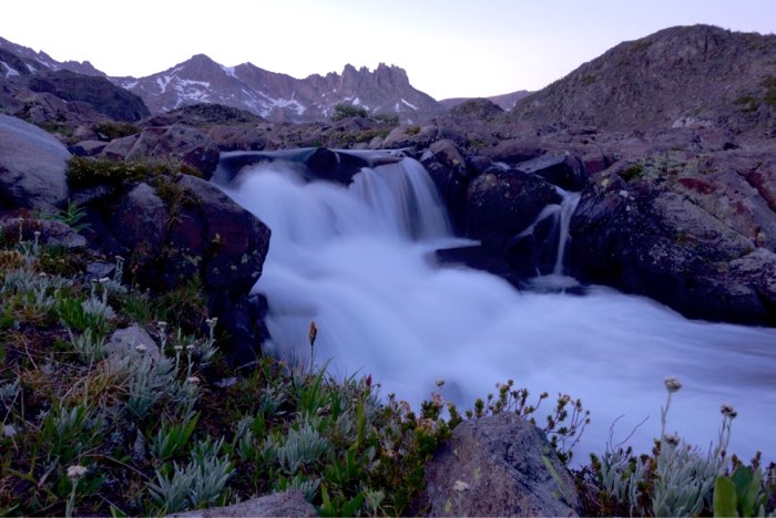 A waterfall near camp, Mount Villard and The Spires on the horizon.