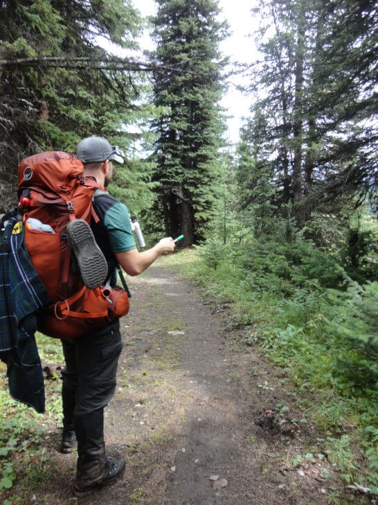 Marvel Pass Backpacking Trail - deploying bear spray and a bear banger.