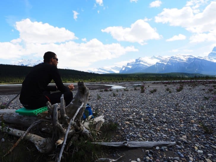 Nahanni River by Canoe: Sitting on top of canoe on a gravelly shore.