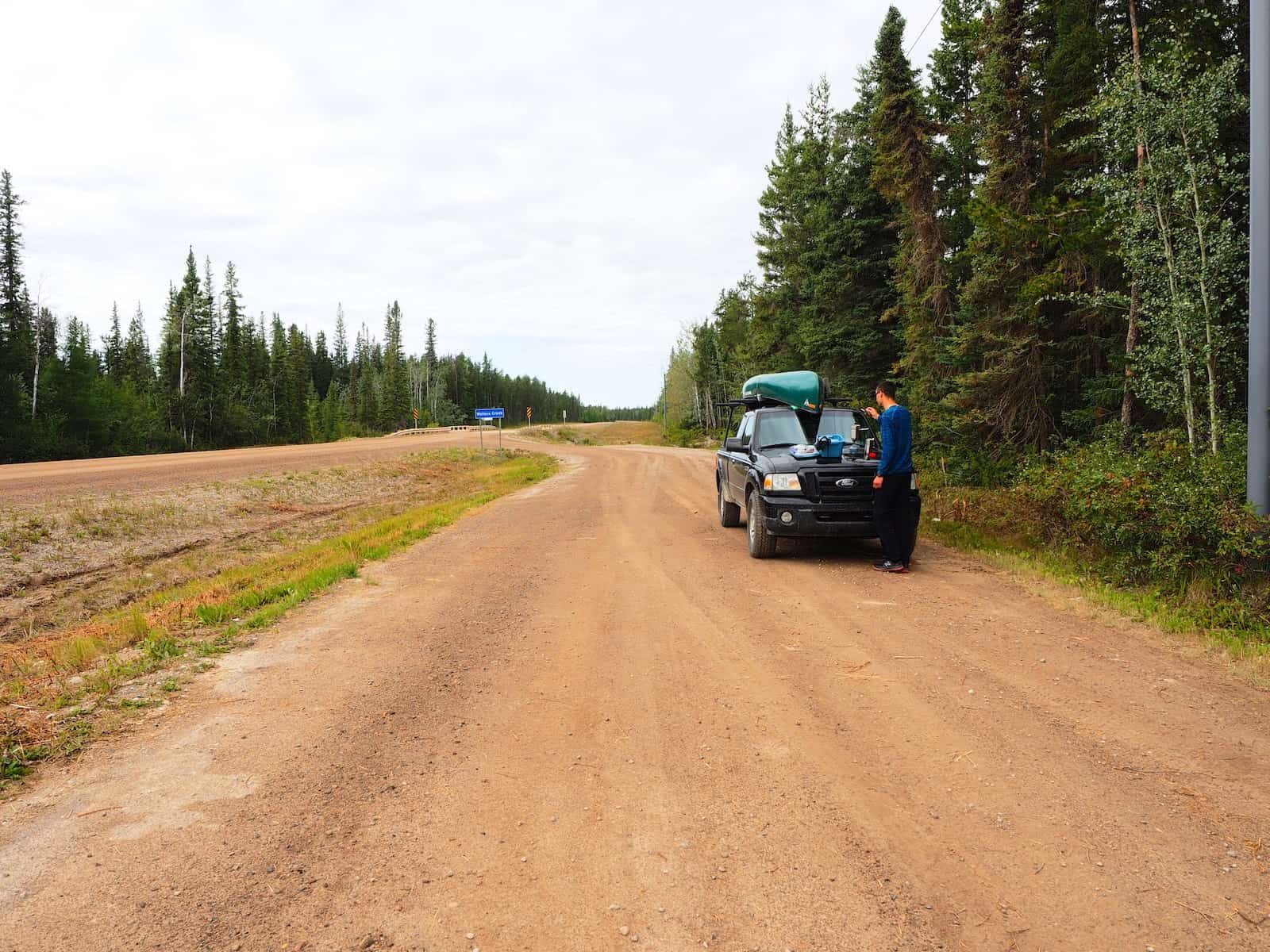 Nahanni River by Canoe: Truck pulled to side of dirt road.