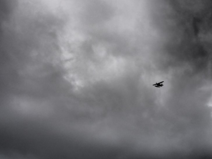 Nahanni River by Canoe: Bush plane silhouetted against clouds.