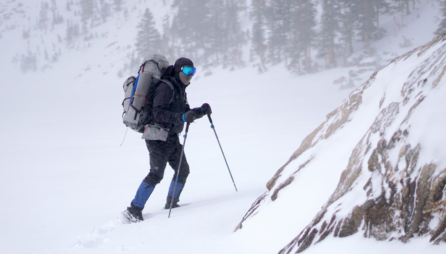 man hiking in a winter storm