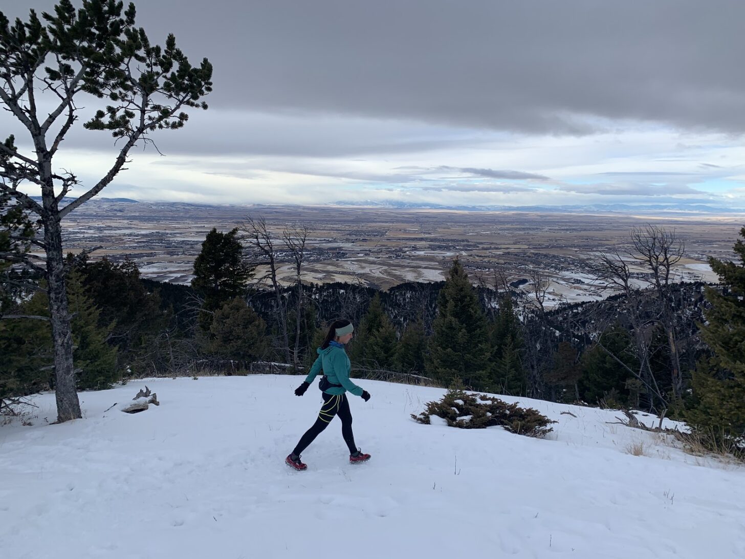 A woman hikes on a hill above the city of Bozeman, Montana