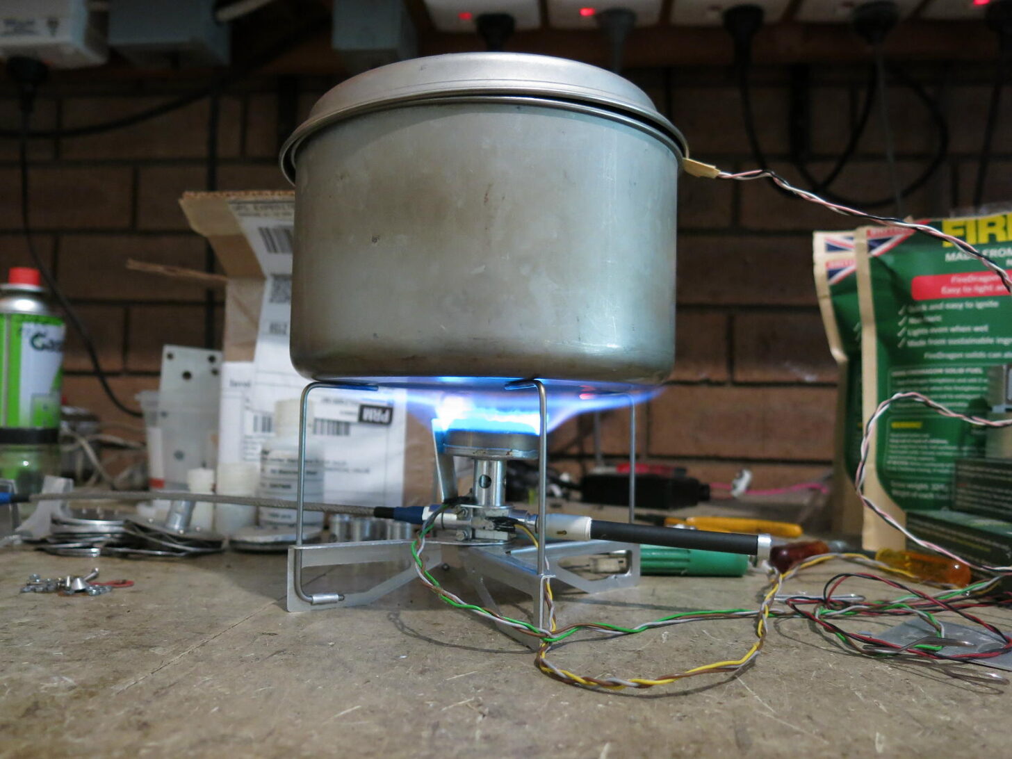 a lit stove and pot in a workshop