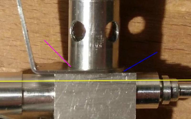 a close-up of a stove assembly, with arrows pointing to relevant parts of the stove.