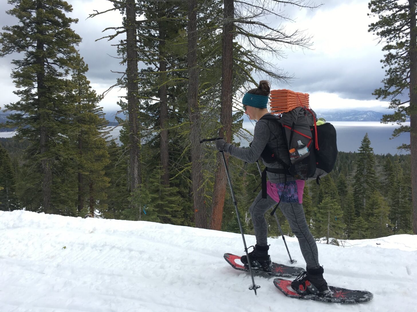 woman snowshoeing and carrying a backpack