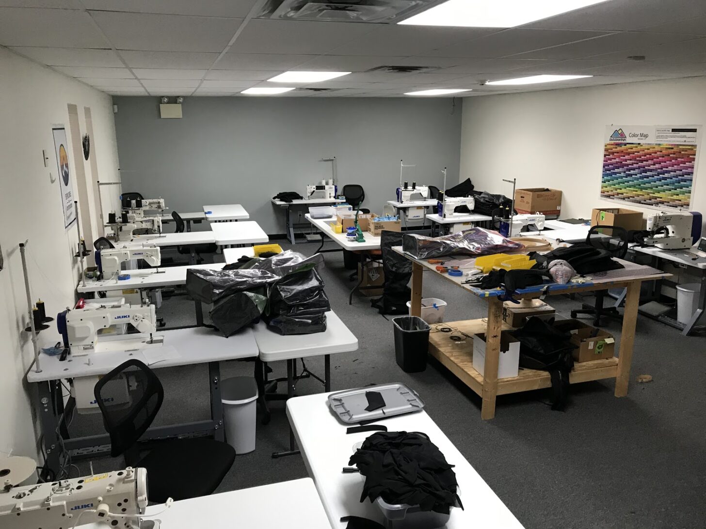 a sewing room with desks and sewing machines