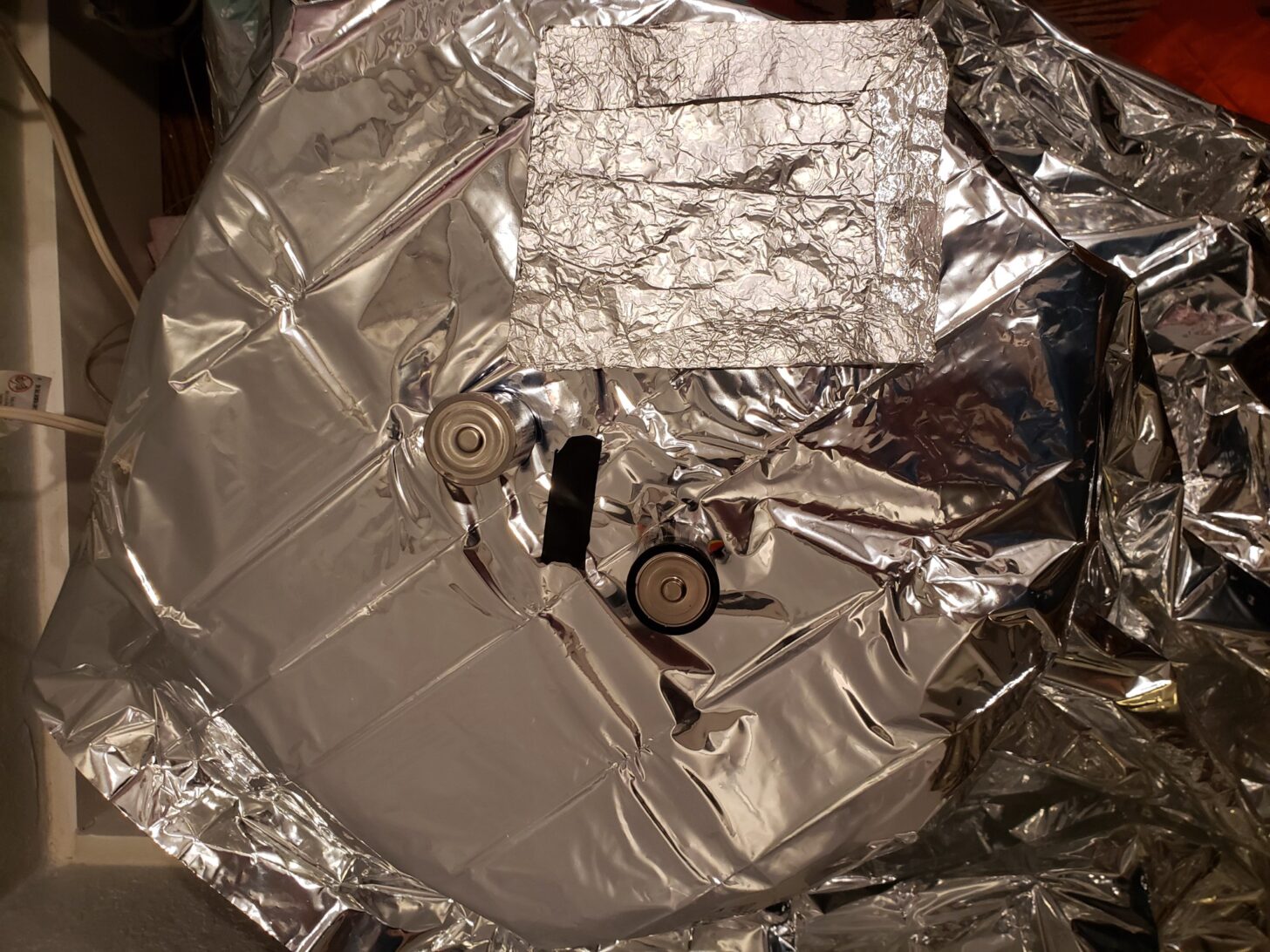 The SOL Survival Blanket stretched over a device for testing.