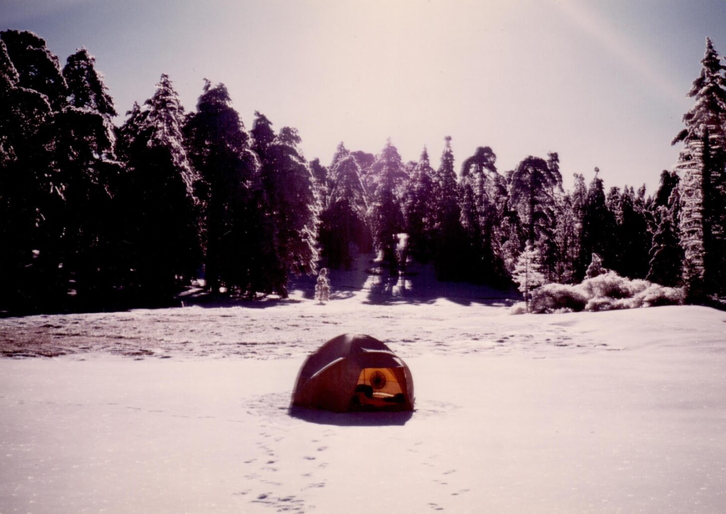 an old geodesic dome tent on a snow field