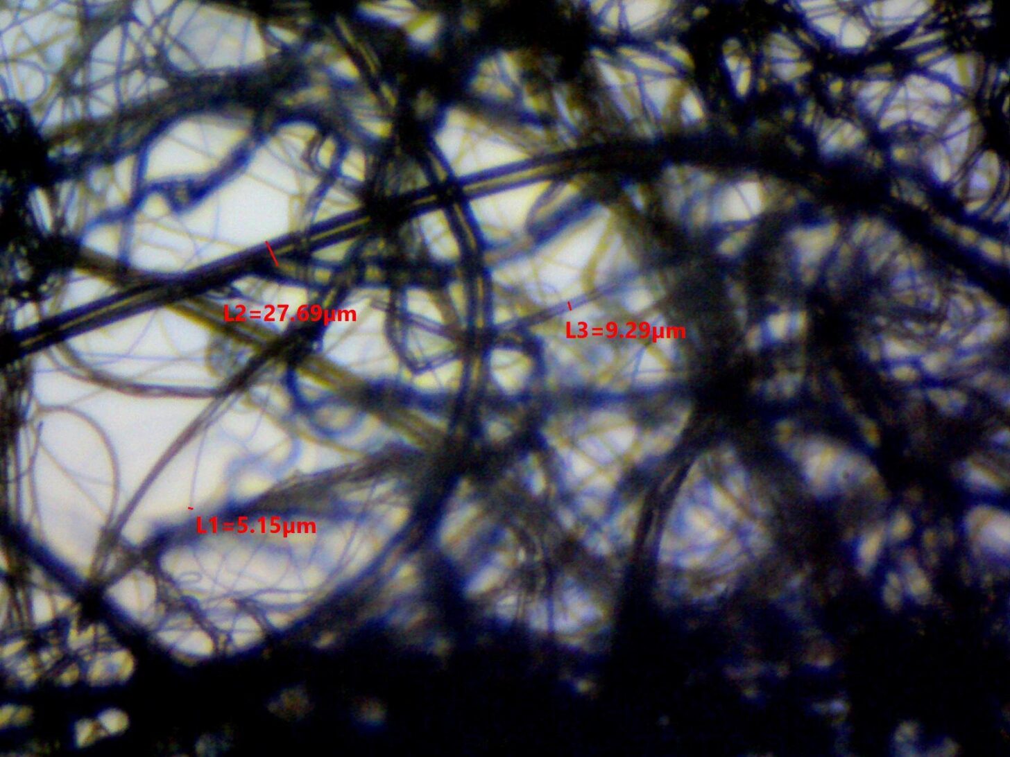 Thinsulate 200G photomicrograph showing fiber diameter measurements of 5.15, 9.29, and 27.69 microns.