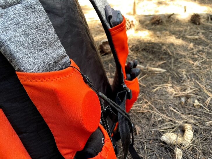 a medium shot of the pack's strap pockets. Items of gear are visible in the pockets.