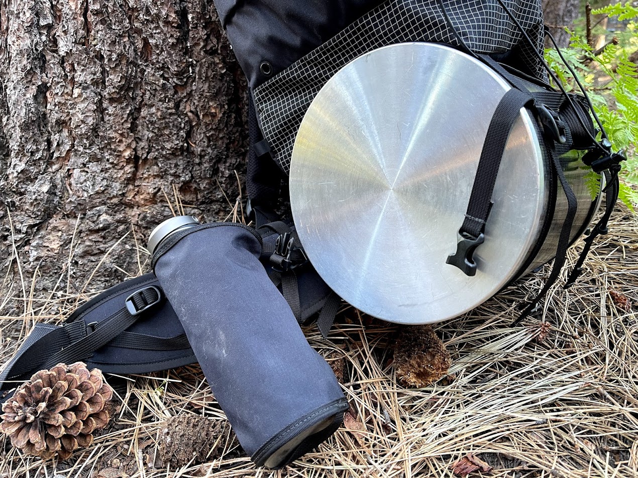 A medium shot of the bear canister attachment system and the water bottle storage system.