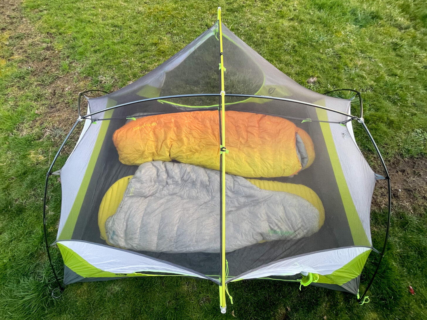 a bird's eye view of the shelter set up without a rain fly so you can see that there are two pads inside.