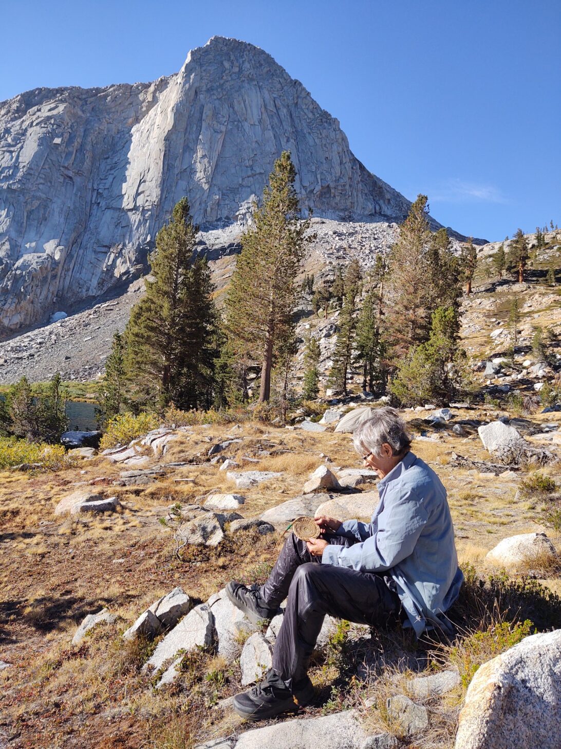 Woman sitting with mountain in background