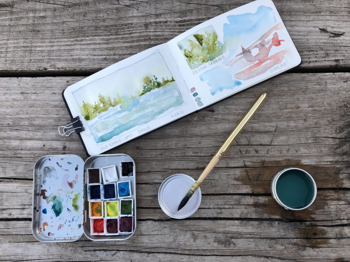 Watercolor paints with notebook