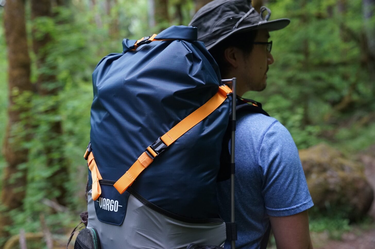 A medium close up of the top of the Vargo Bog ExoTi pack being worn by a man with his back to the camera.
