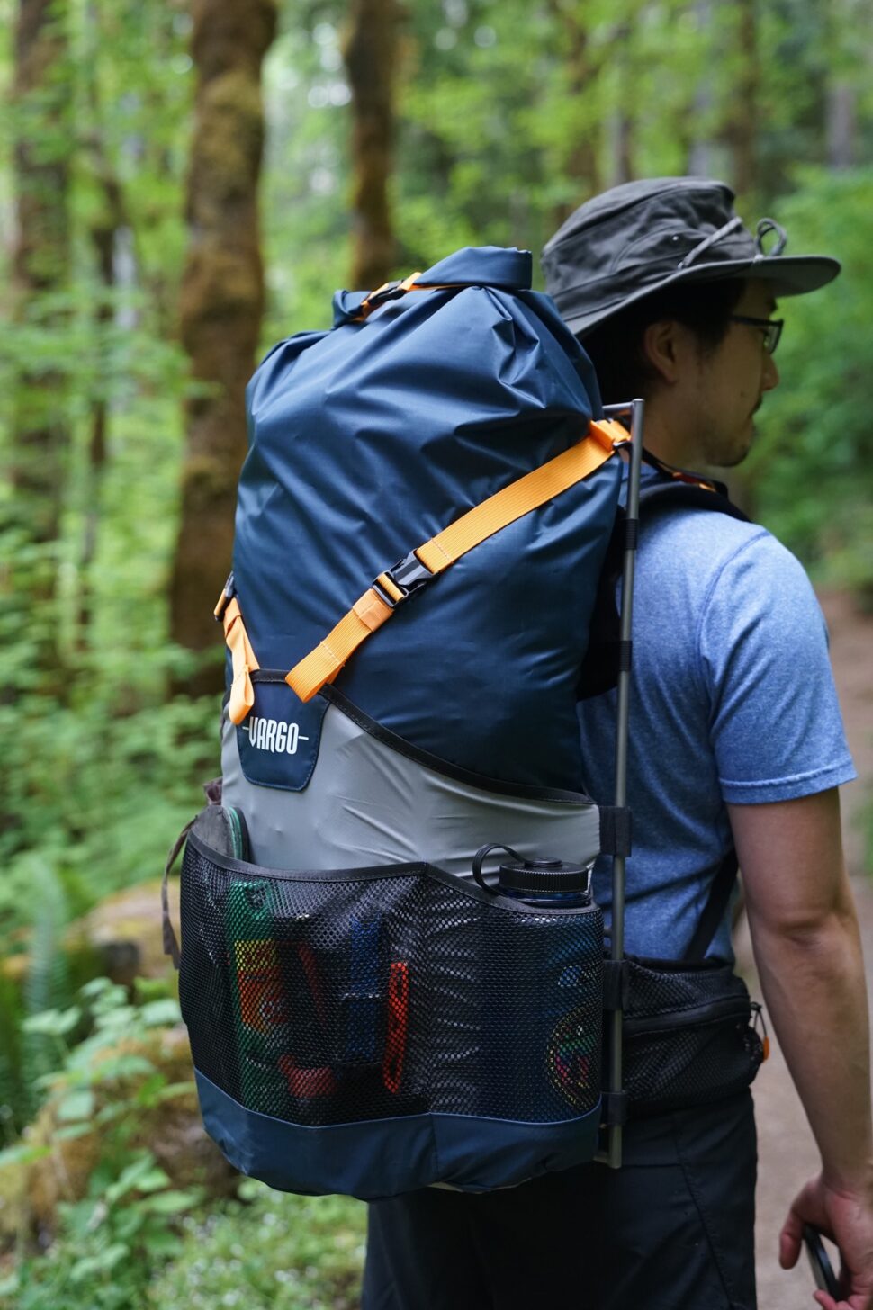 a man stands with his back to the camera while wearing the Vargo ExoTi BOG pack.