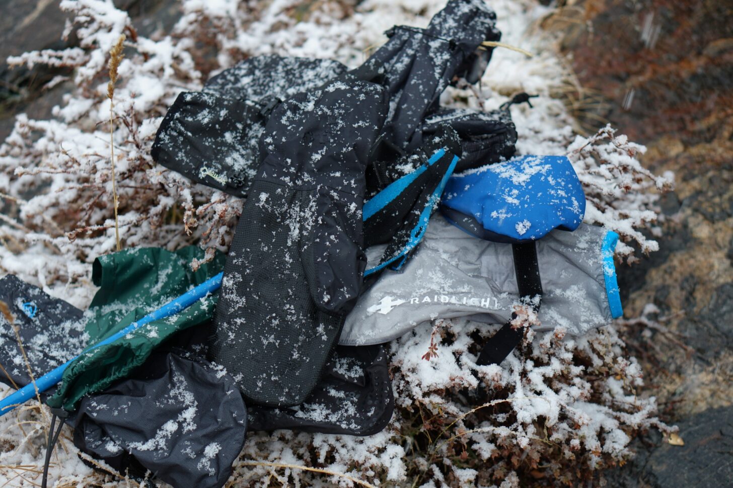 rain mitts in a pile with snow falling