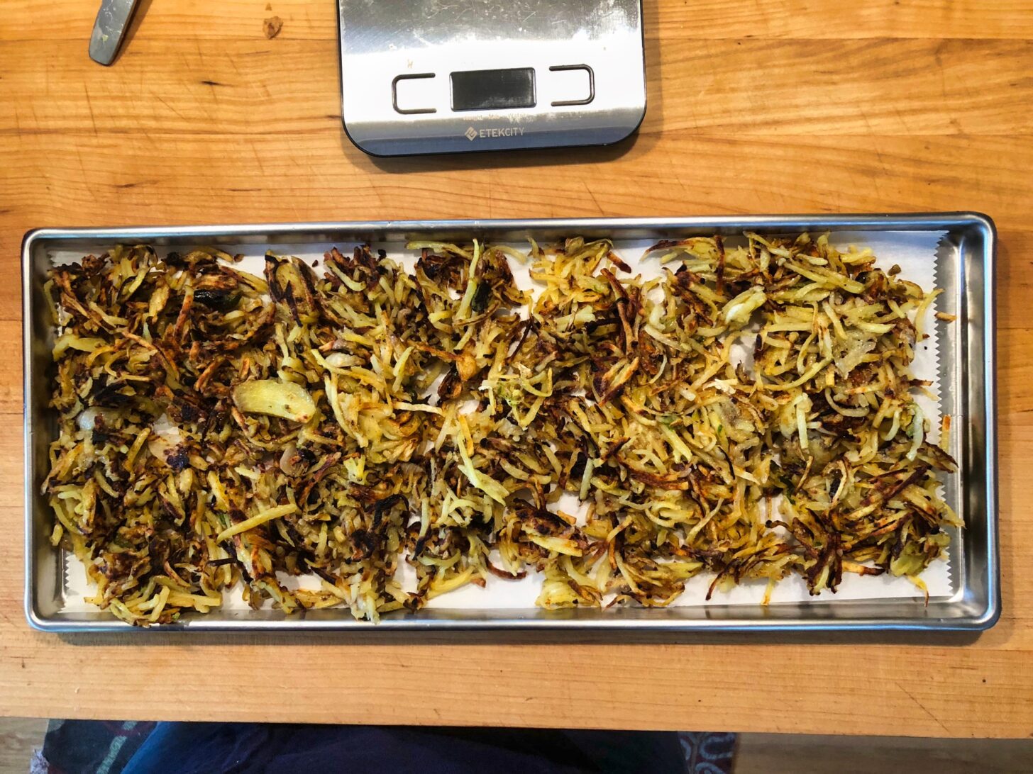 a tray of cooked hashbrows about to be inserted into a freeze drying machine