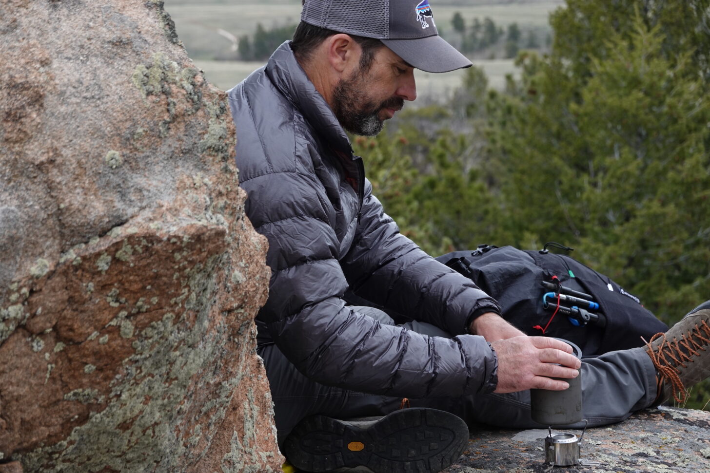 hiker cooking on an alcohol stove