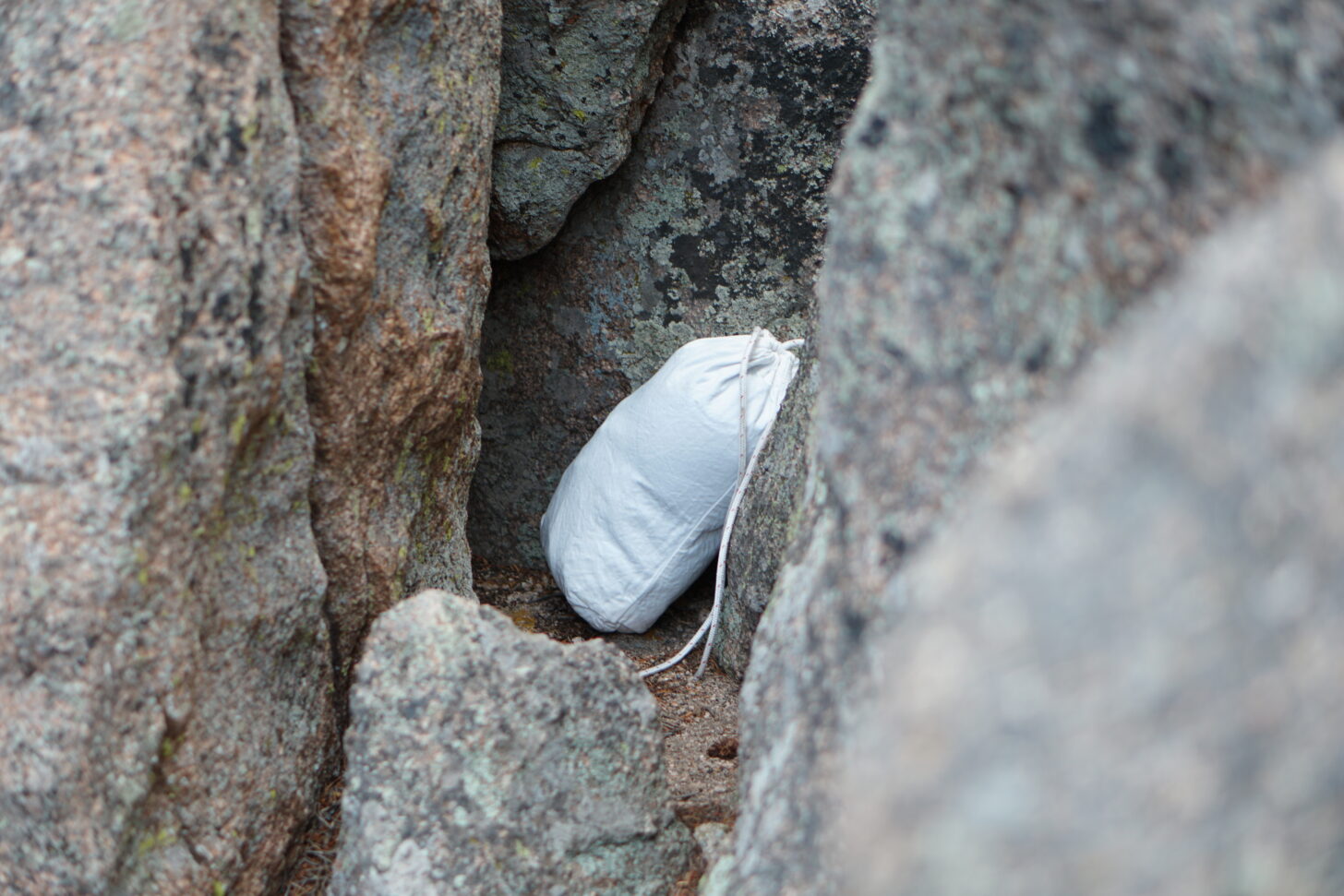 ursack hidden in a rock crevice