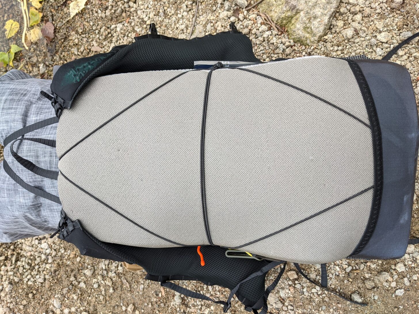 a shot from above of the Nashville Pack Cutaway backpac on the ground with a sleeping pad attached.