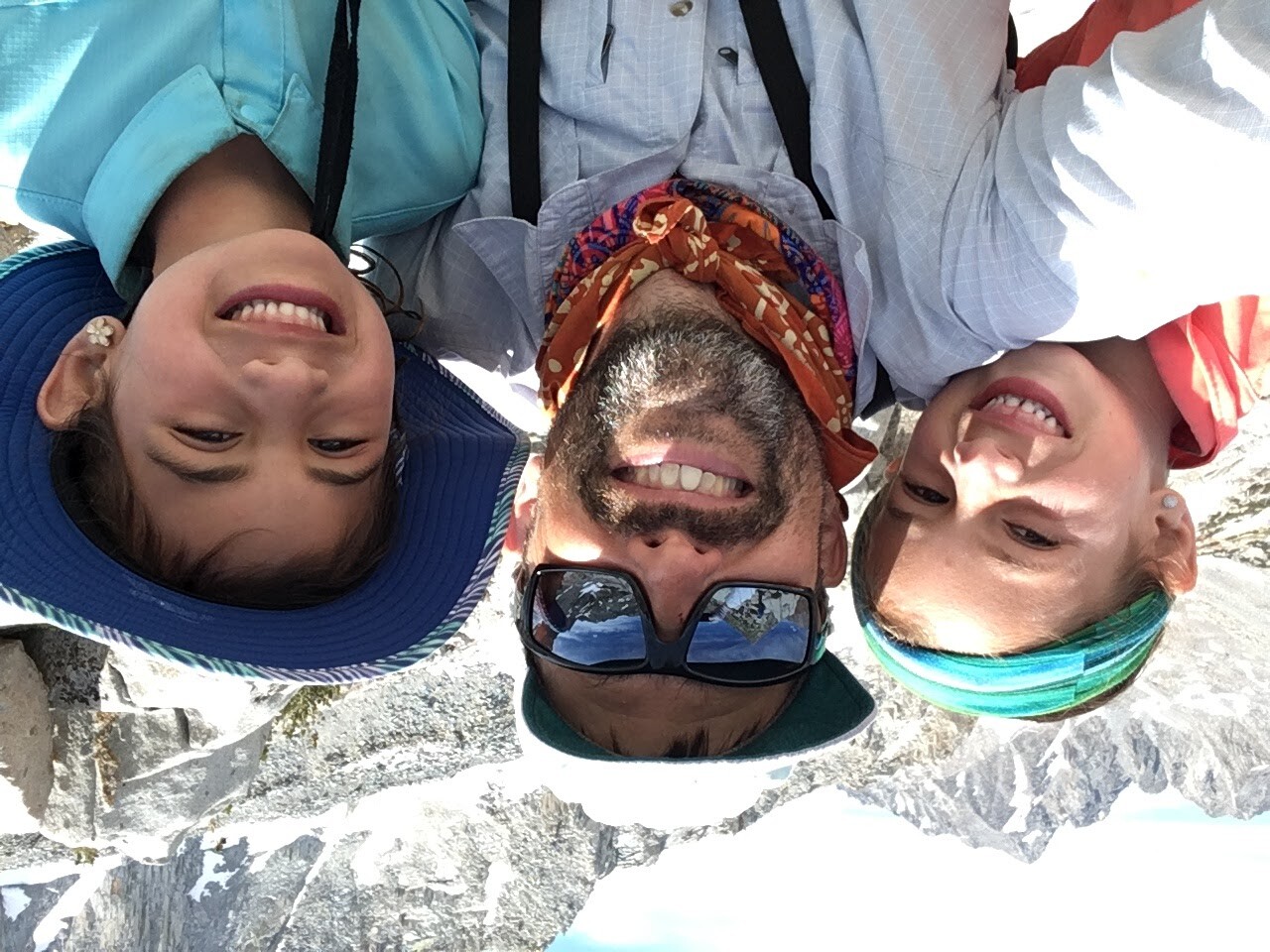 man and two children enjoying the high mountain sun on a backpacking trip