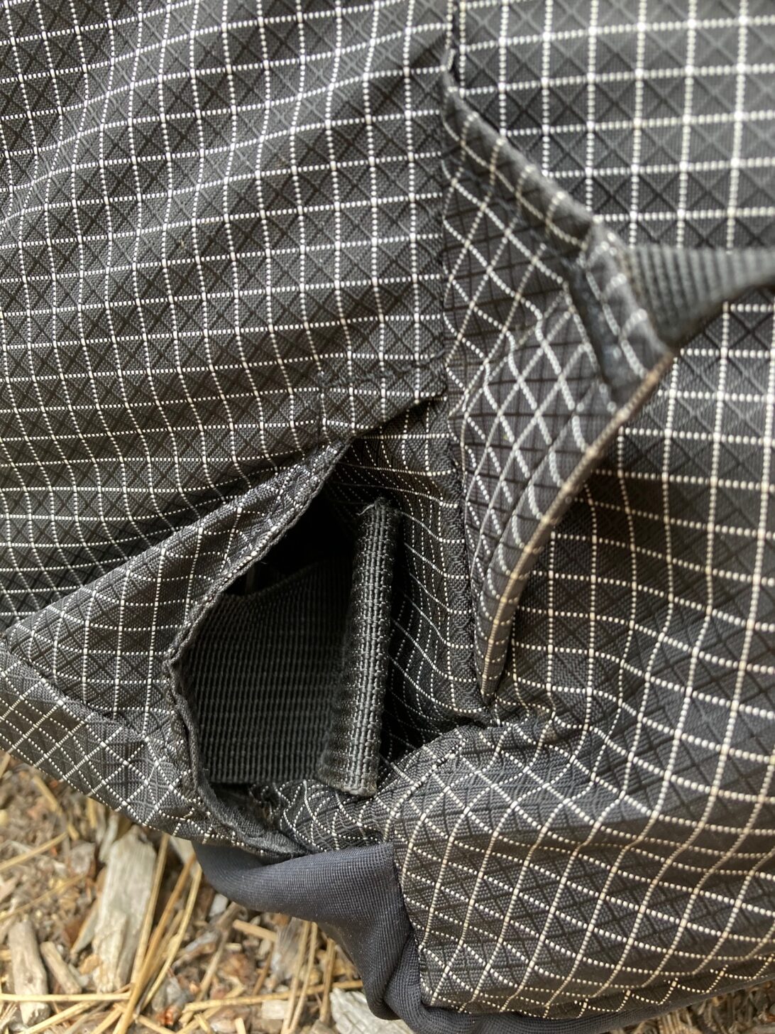 A close-up photograph of a hipbelt stowed into a pocket.