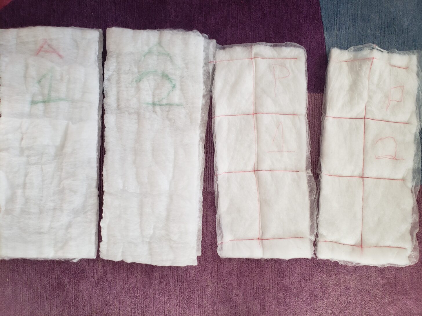 four samples of synthetic insulation side by side.