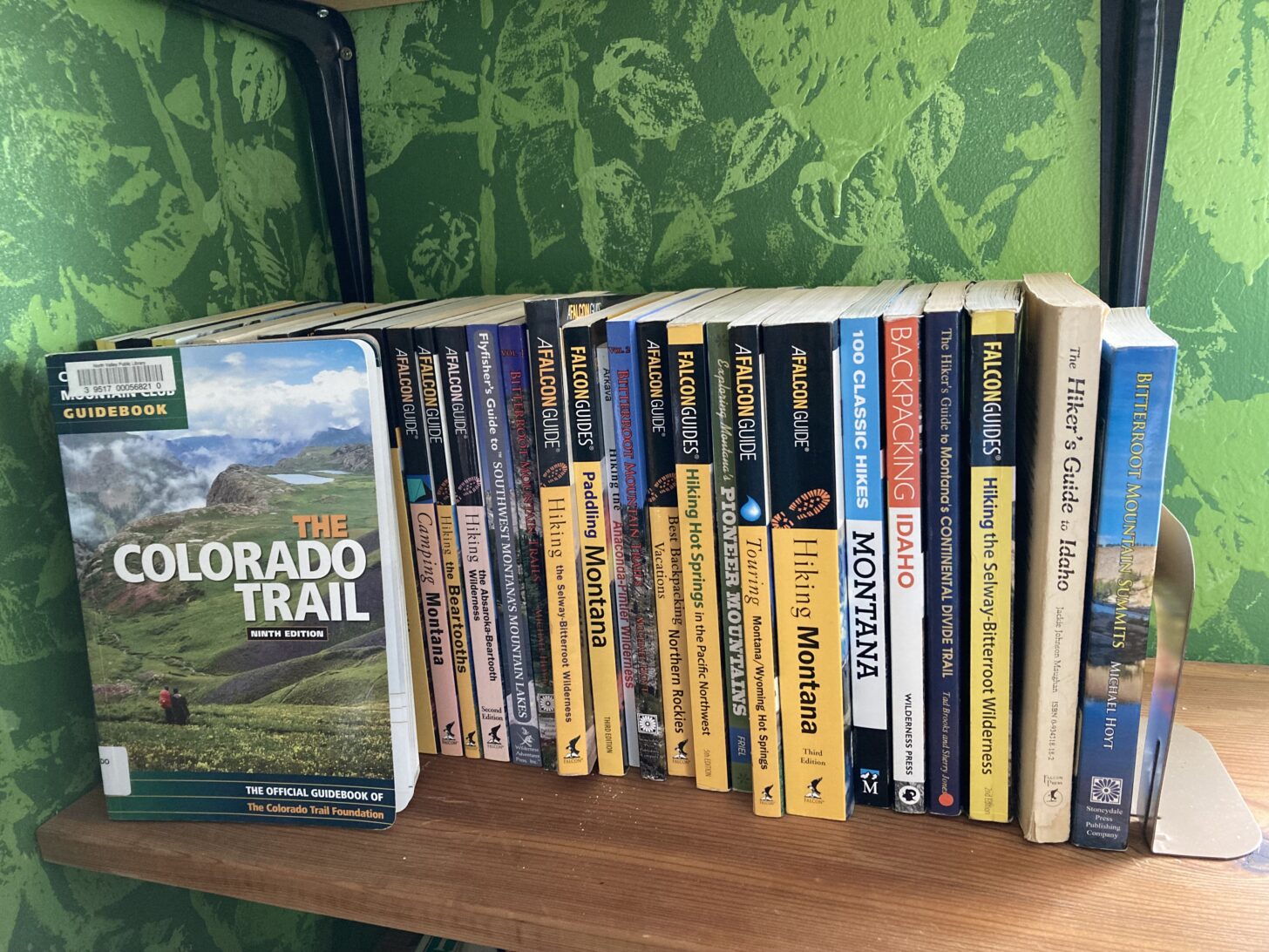 A guidebook for The Colorado Trail sits in front of several guidebooks for Montana and Idaho.