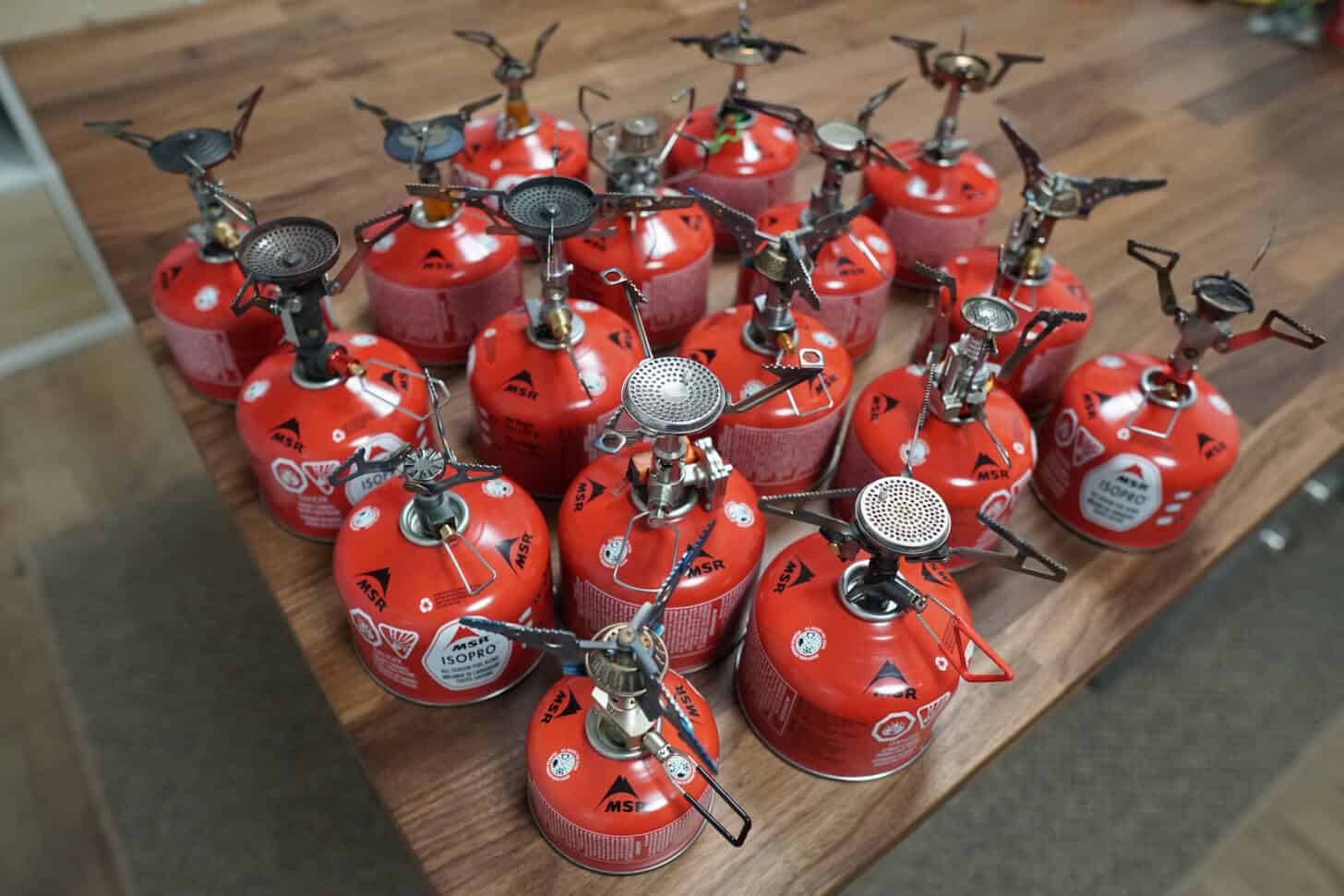 a collection of stoves attached to fuel canisters.
