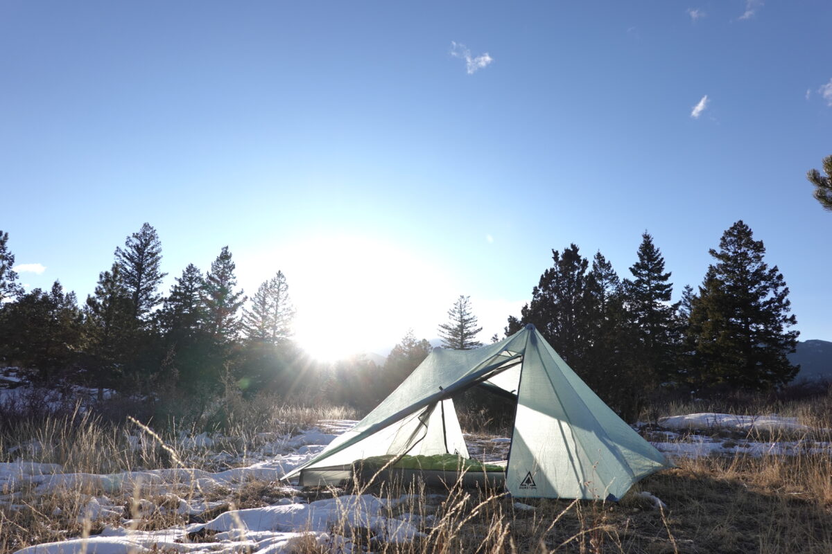 a tent set up in a snowy field