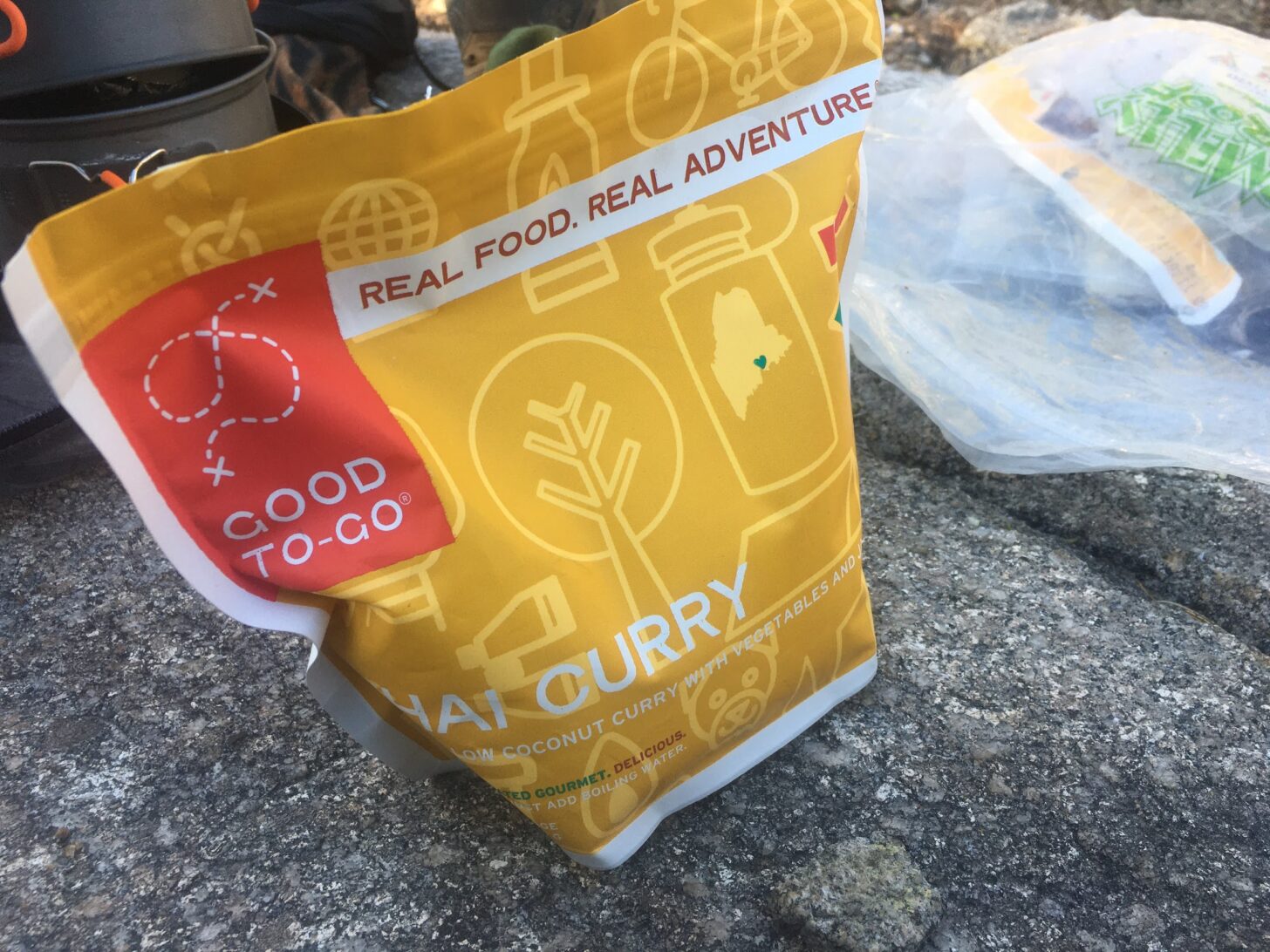 a bag of good to go thai curry sits on a rock in the backcountry