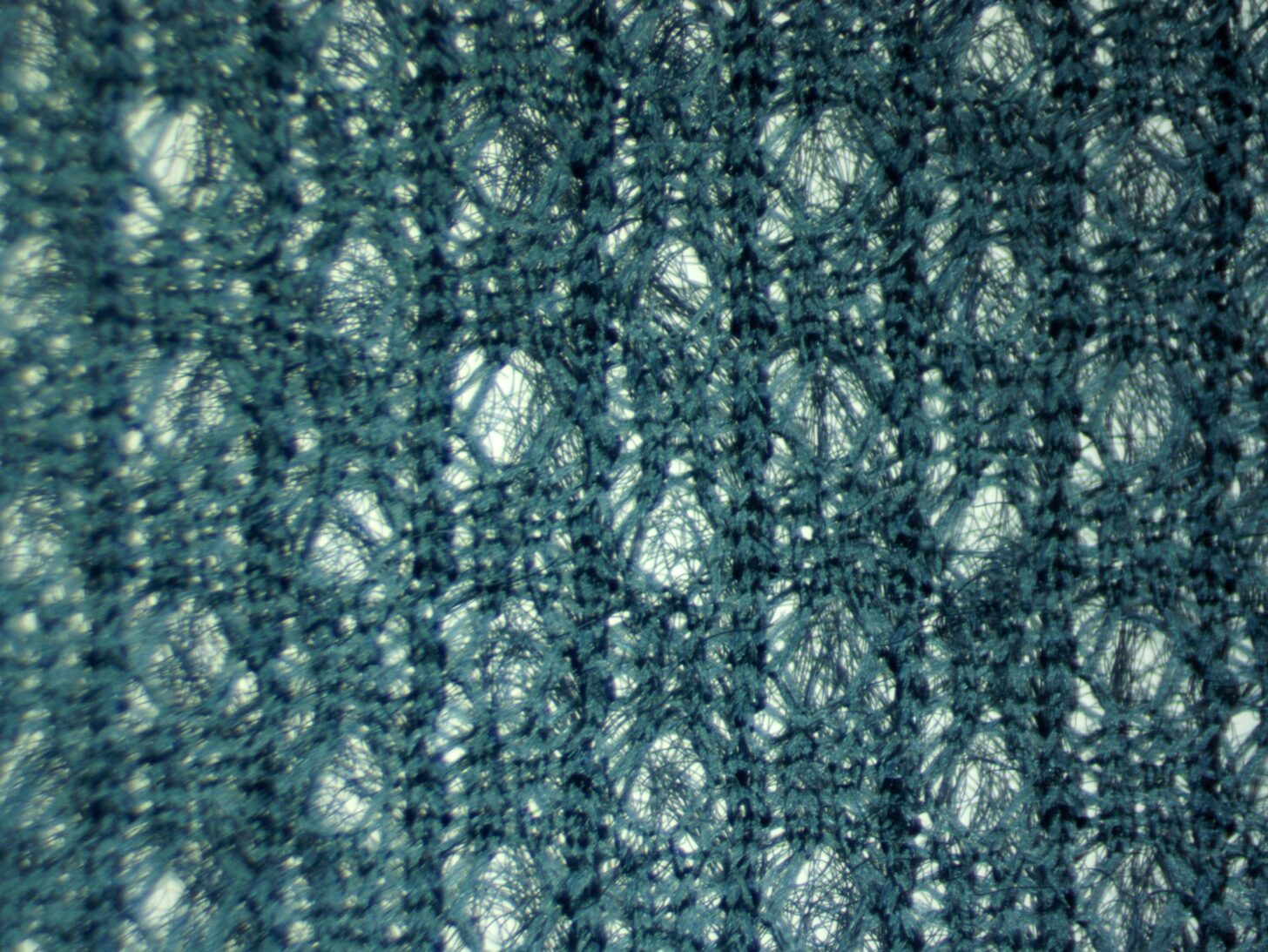 A close-up of the face of the mountain hardware airmesh fabric. The photo showcases the open knit of the fabric.