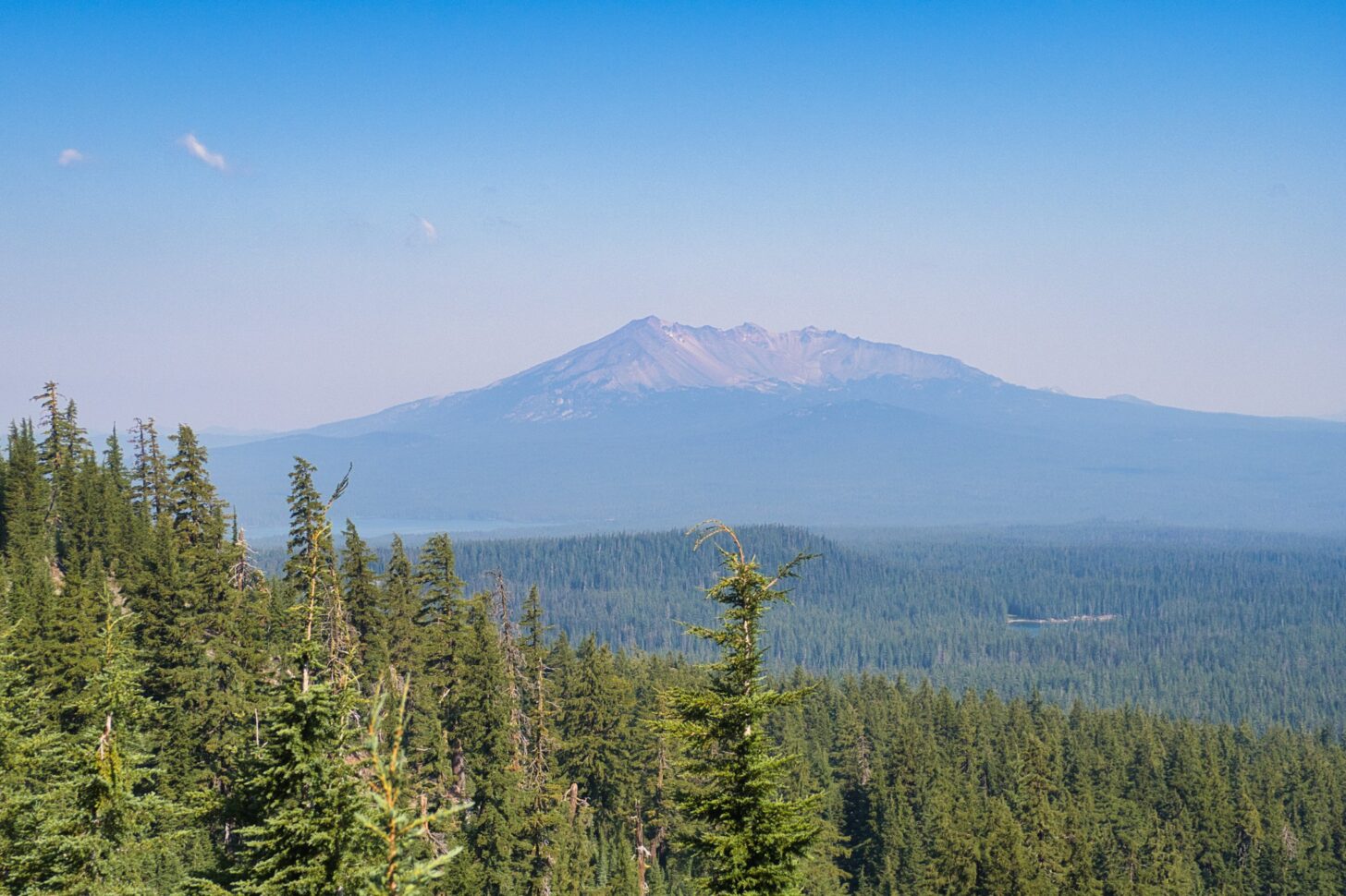 A large, isolated, conical mountain far in the distance.