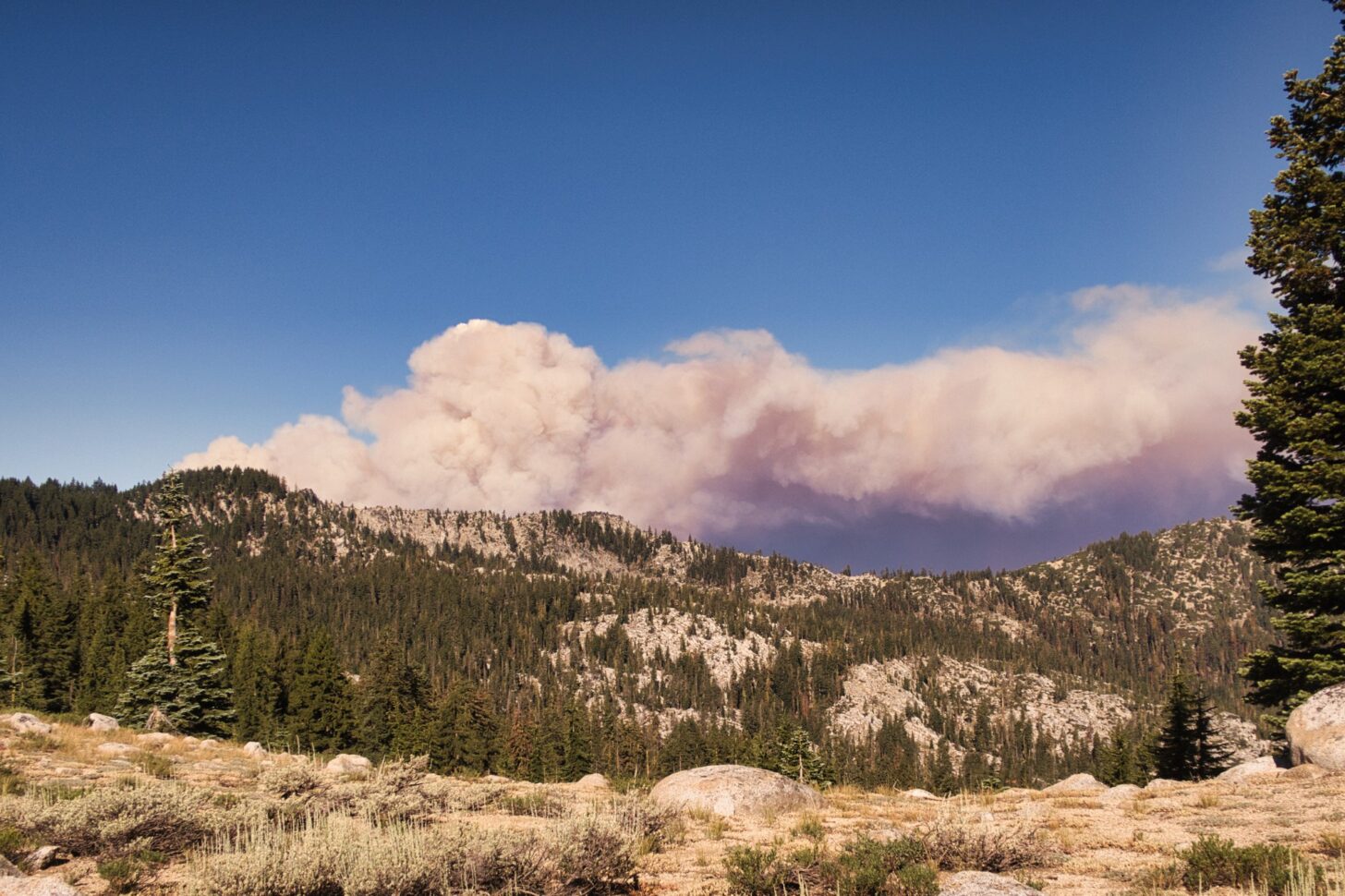 dark smoke on the horizon of a mountain landscape.