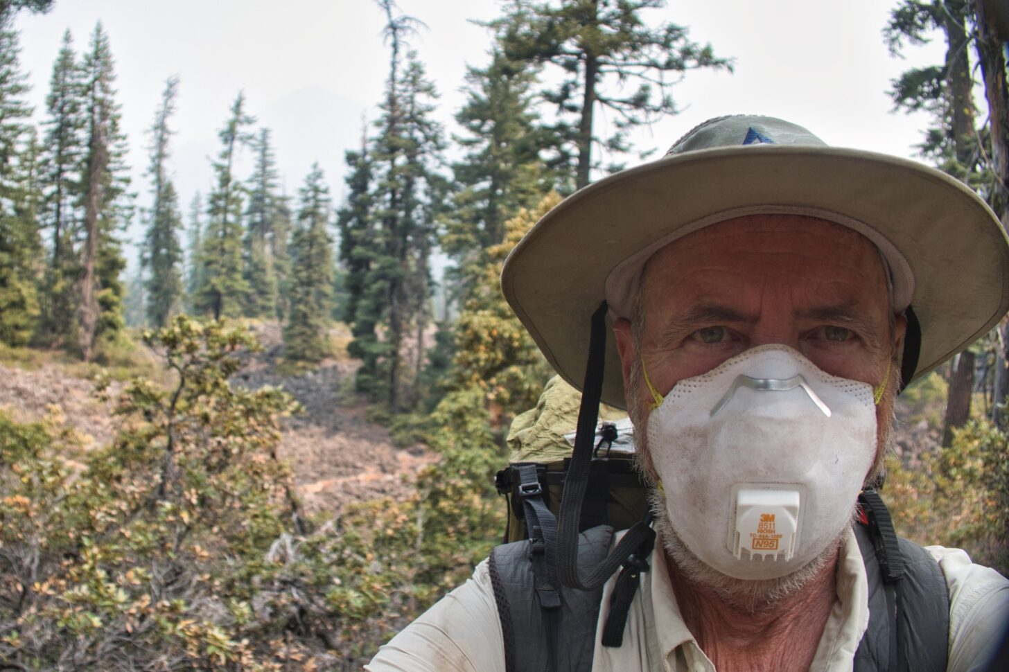 a man wears an N95 mask and looks directly into the camera.