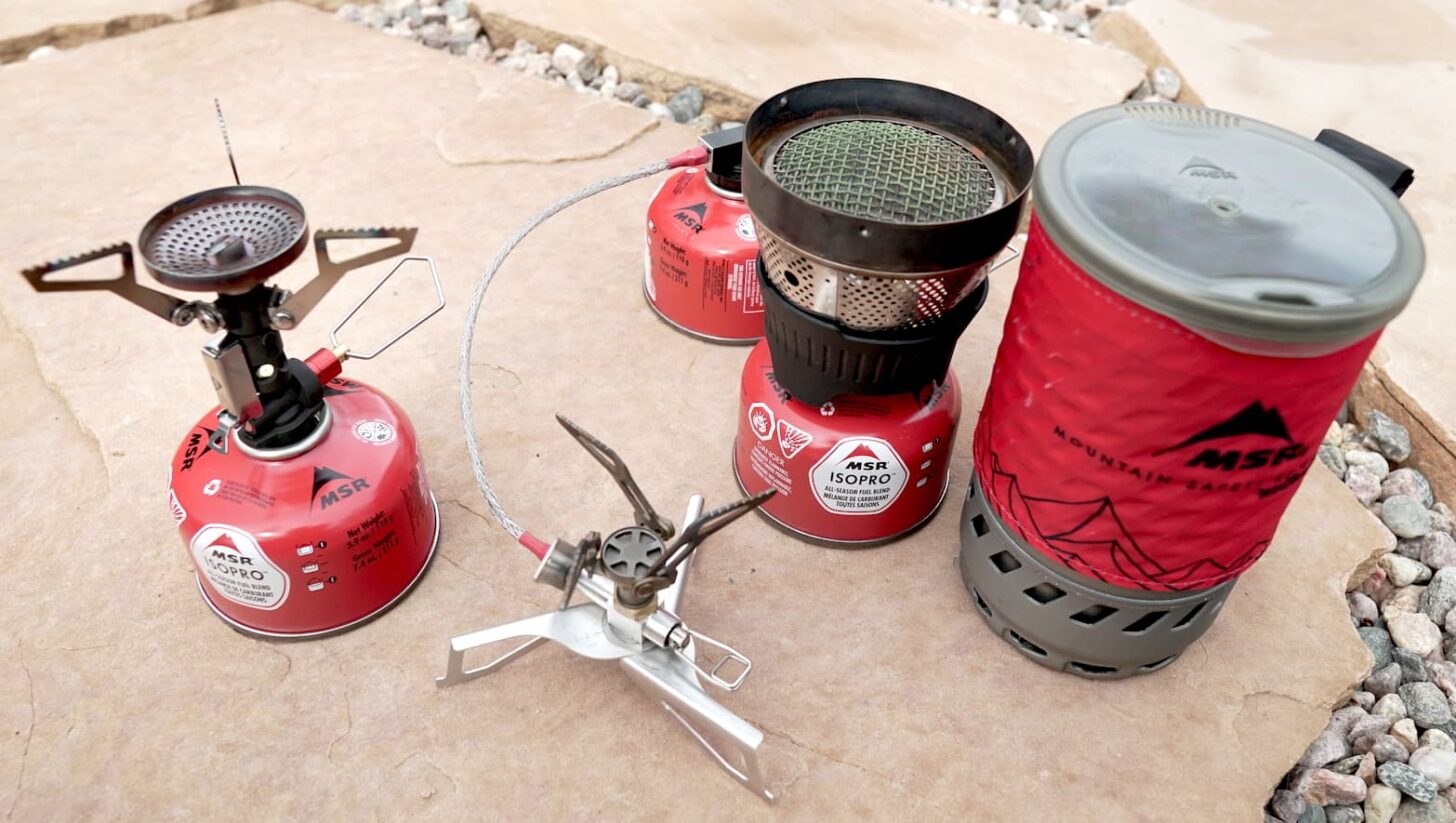 From left to right: An upright canister stove, a remote canister stove, and an integrated canister stove
