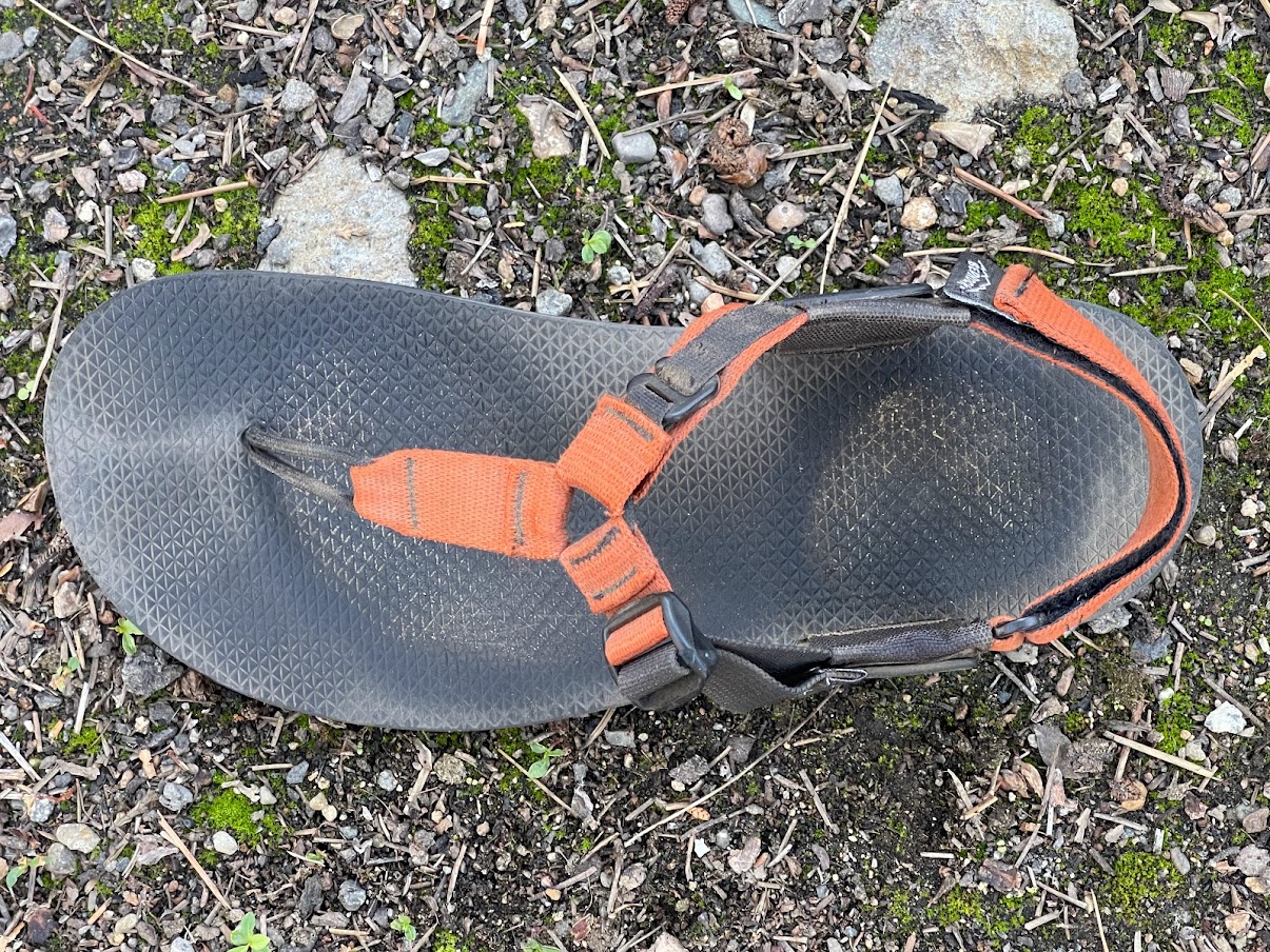A shot from above showing an indention of a foot in the hard rubber of the sandal footbed.