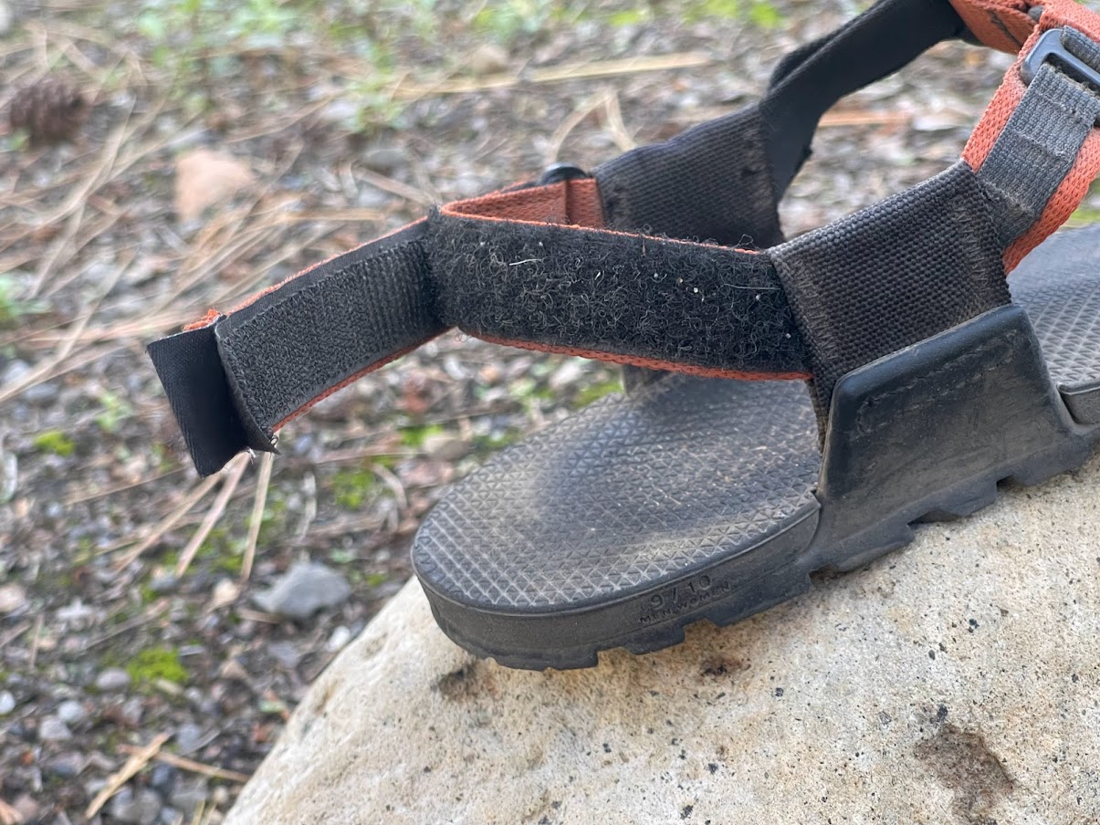a close-up of a velcro strap on the rear of the sandal