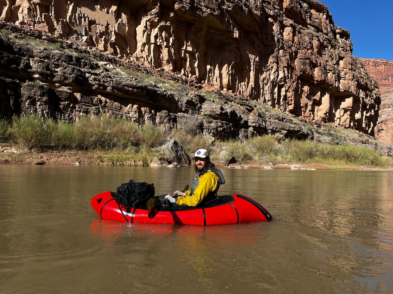 Red packraft on river.