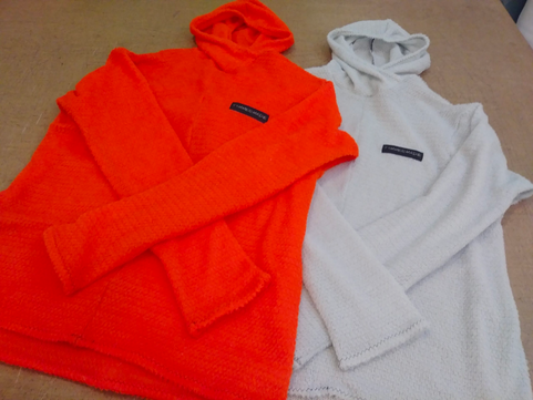 fleece hoodies, one orange, one white