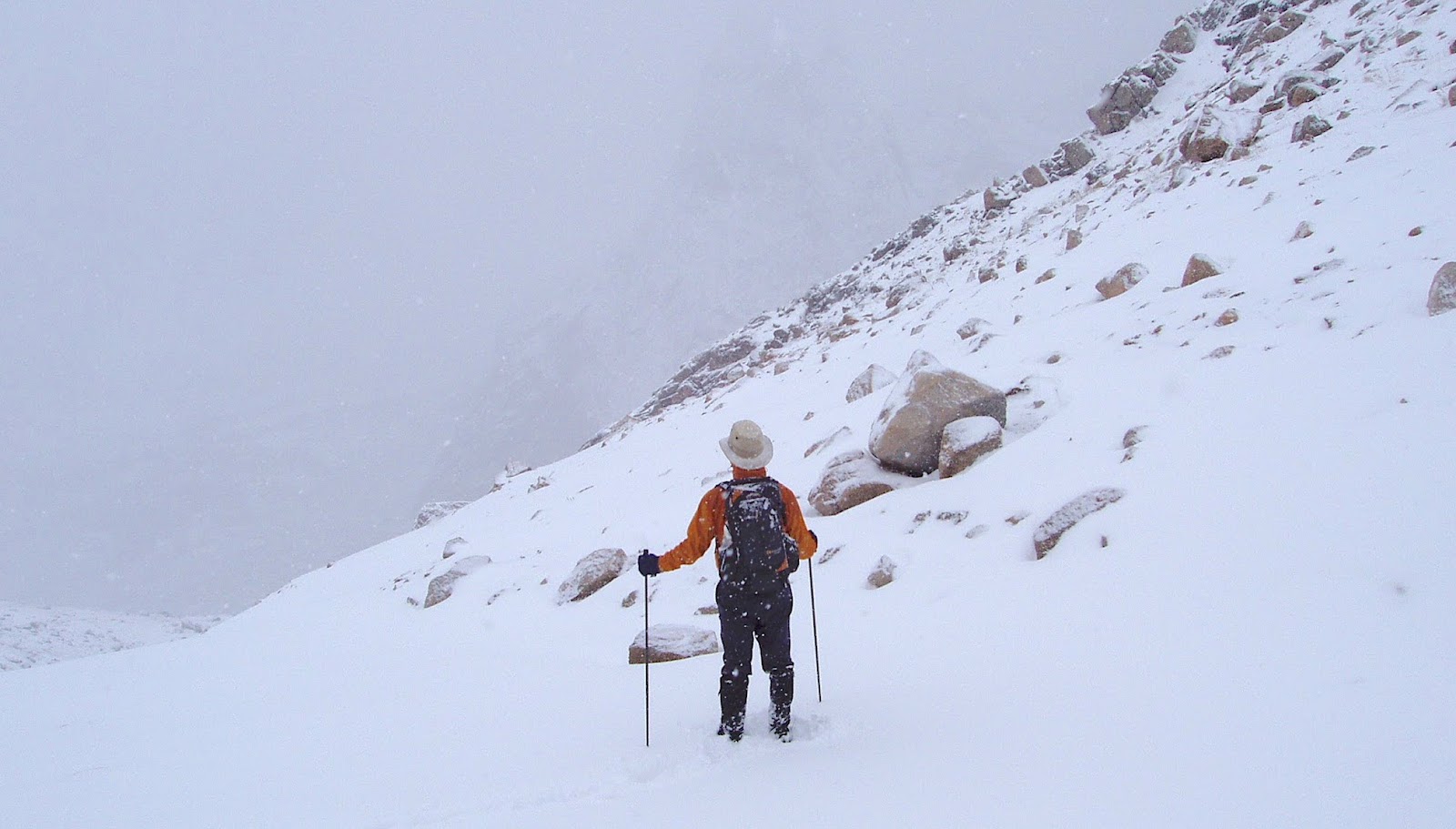 Hiker at mountain pass in Winter