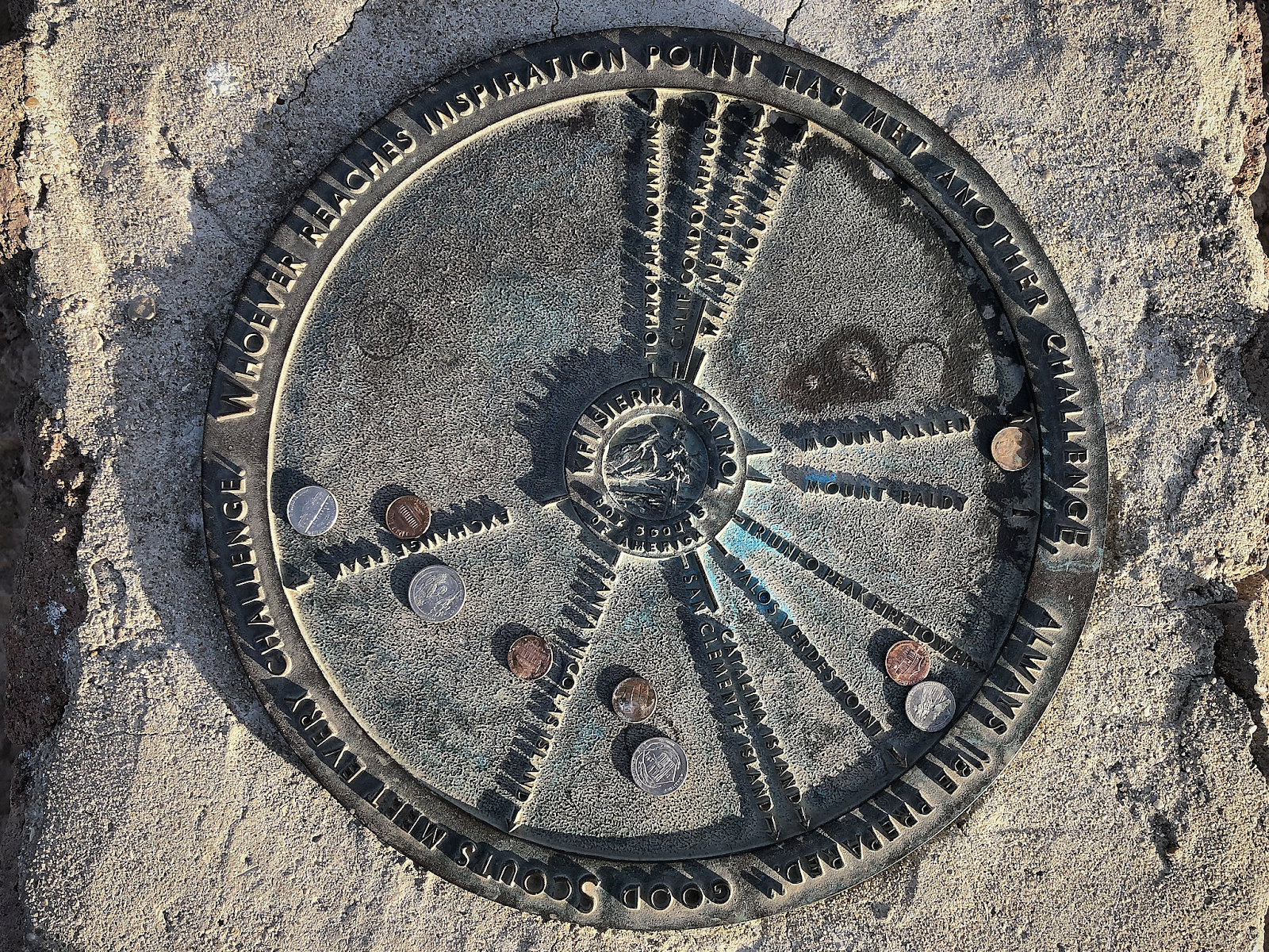 a summit compass in the middle of a rock