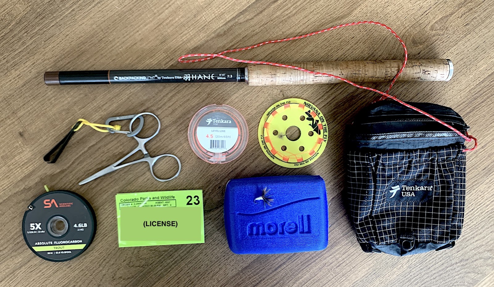 the contents of a fishing kit laid out on a table
