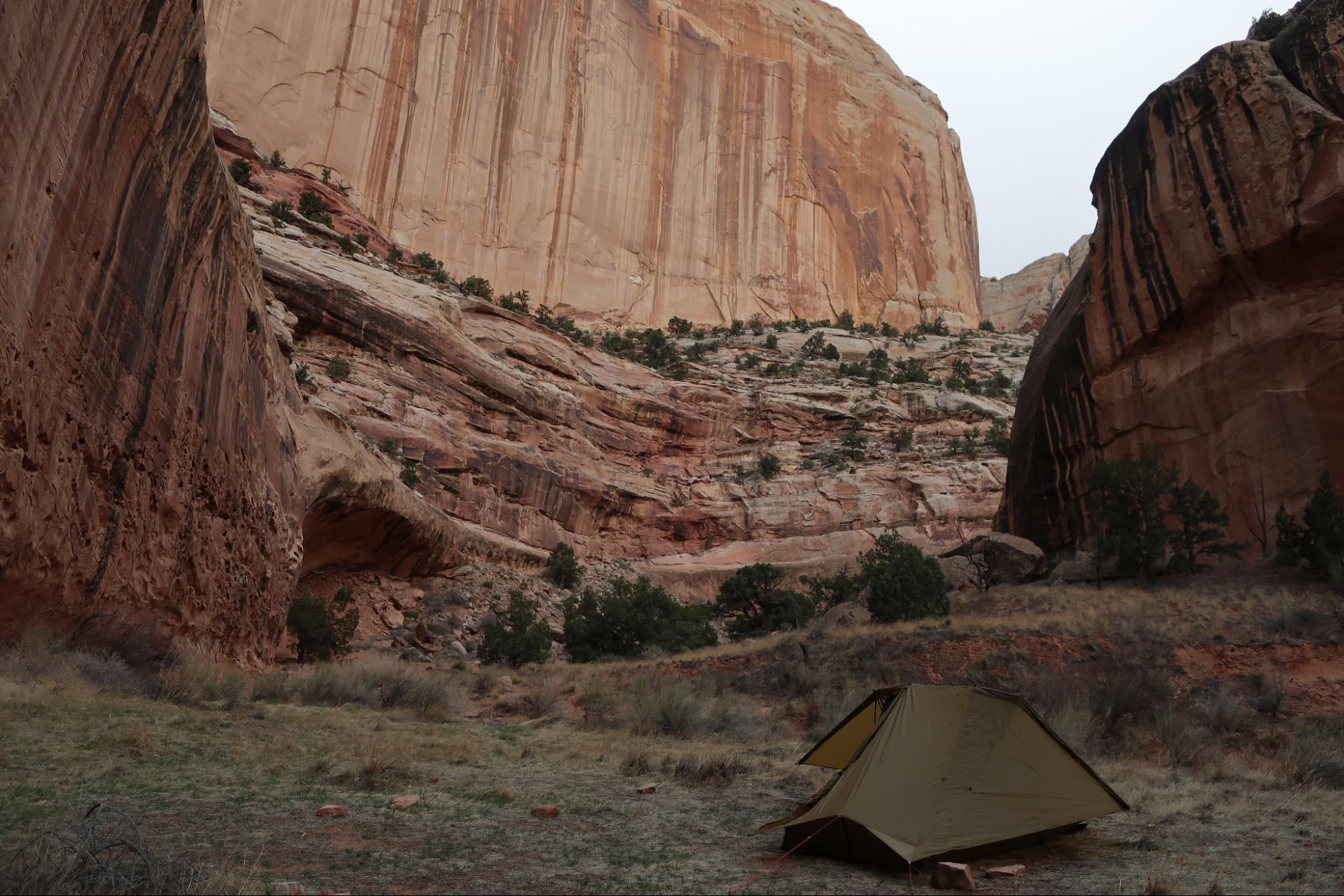 a tent pitched up in the middle of a canyon