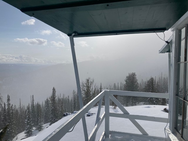 a view of a snowy mountain from a porch
