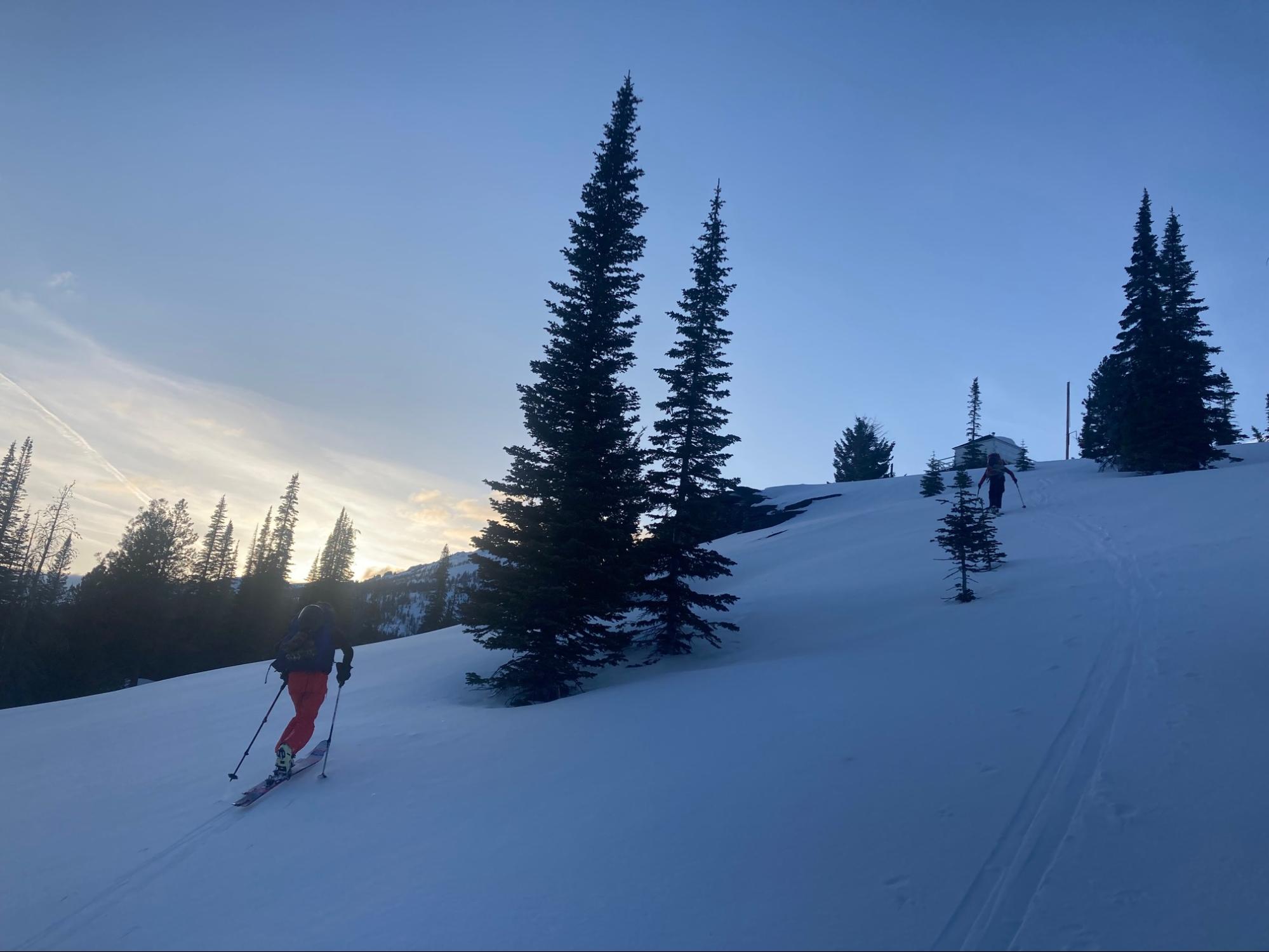 a person riding skis down a snow covered slope