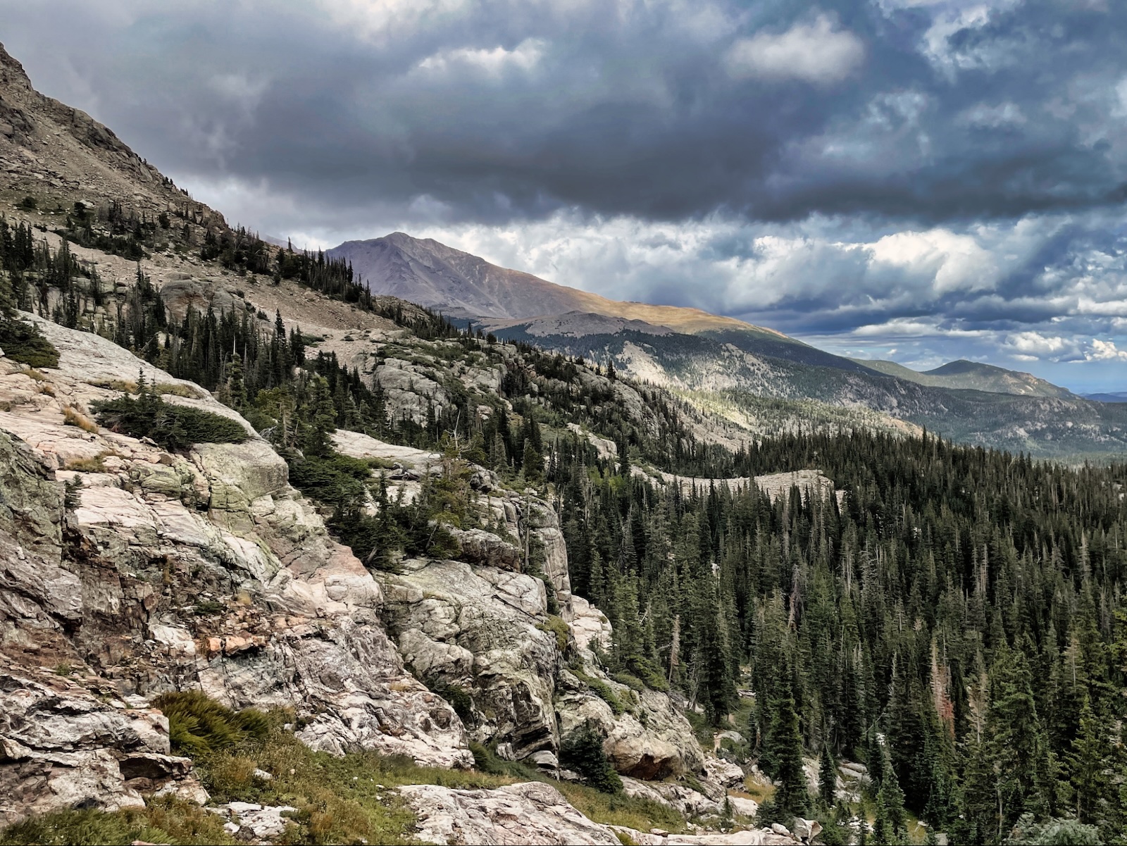 a view of a mountain range with a cloudy sky